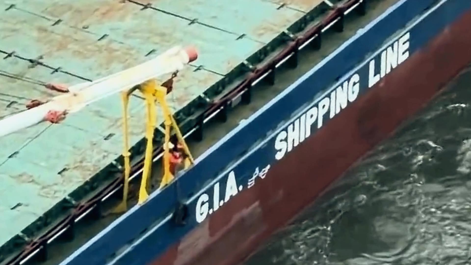 The blue GIA Shipping Line ship, G.I.A. Shipping Line on its hull, in the Miami River