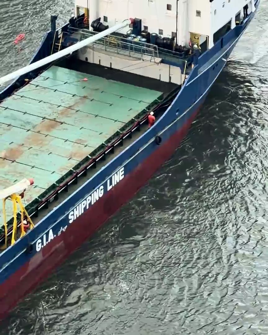 The GIA Shipping Line vessel, G.I.A. Shipping Line on its navy hull, in the Miami River